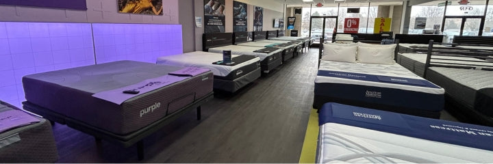 American Mattress store with Purple. TempurPedic, and other brands of mattresses lined up